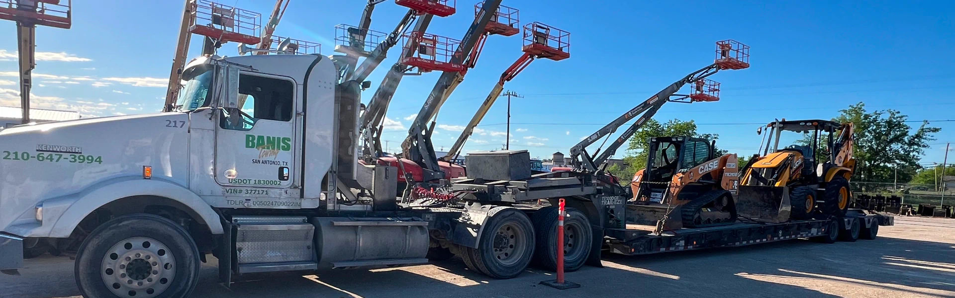 heavy equipments on a white towing truck