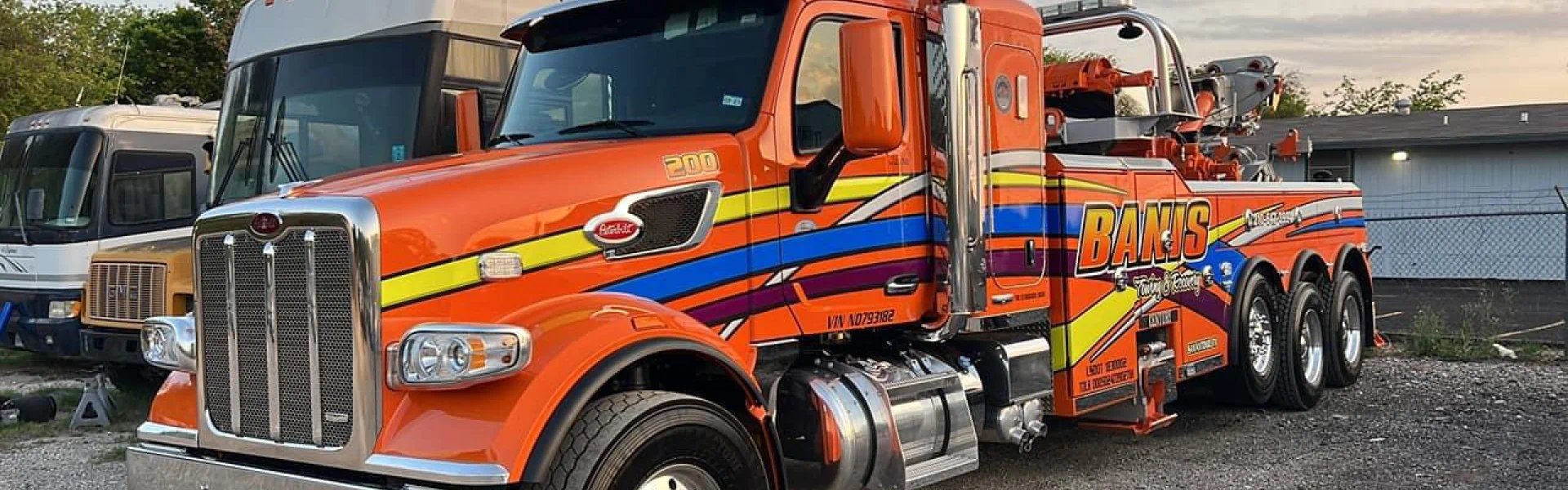 orange service truck of banis towing on standby