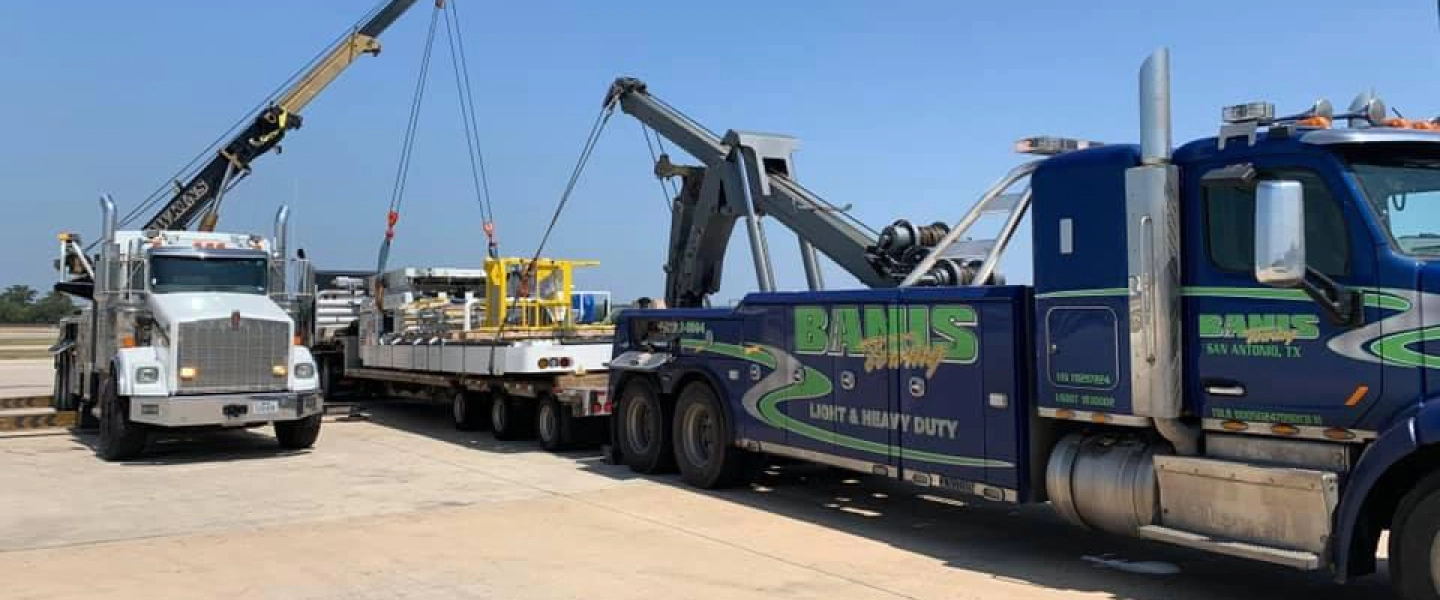 tow trucks hauling heavy equipment